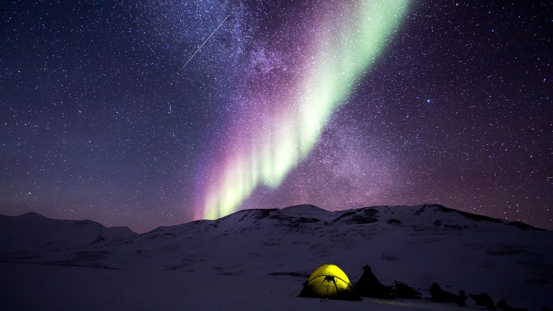 Camping in mountains with sky lights.