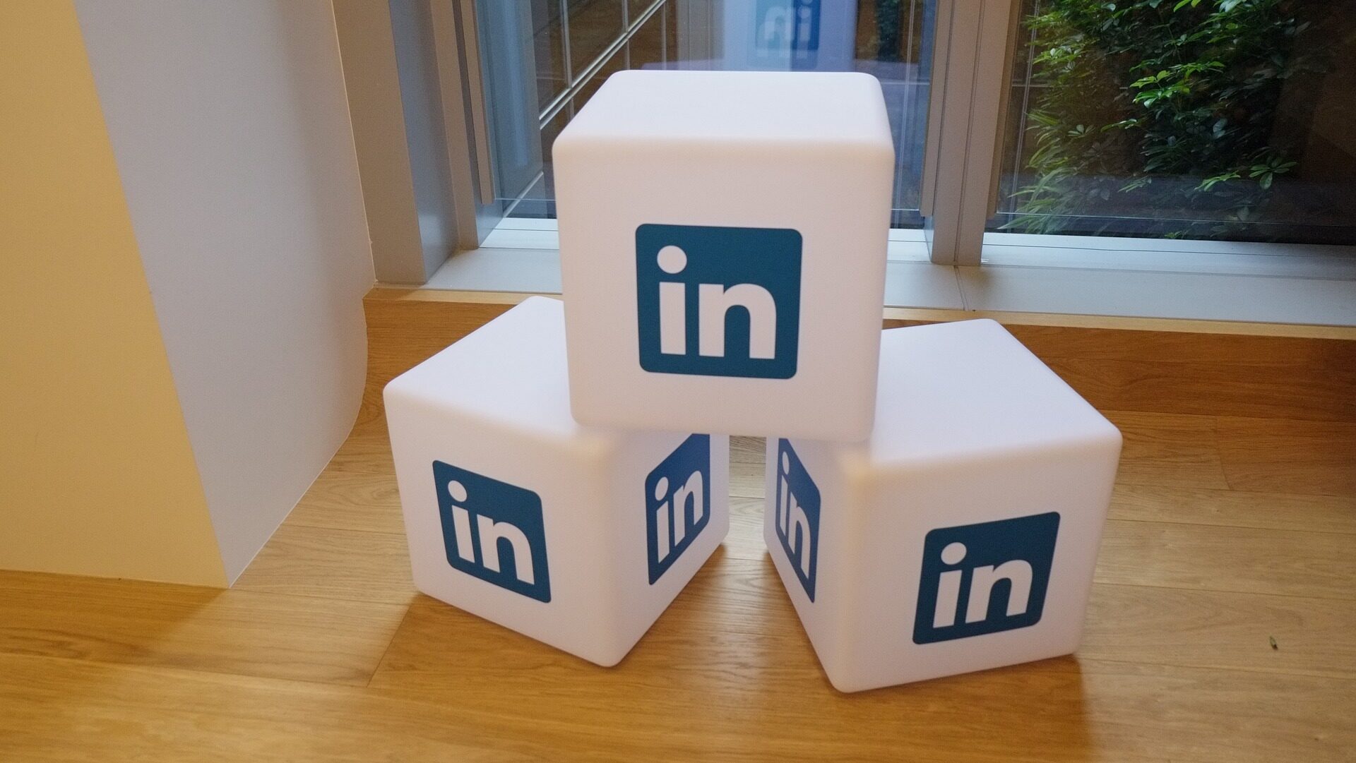 Large LinkedIn branded blocks on a wooden floor.